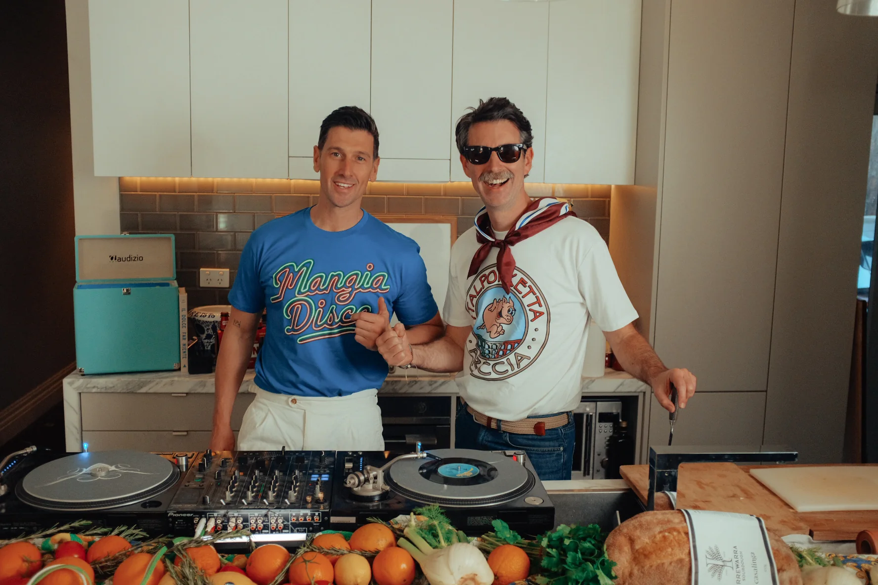 Matt and Andy behind the turntables in the Mangia Disco kitchen