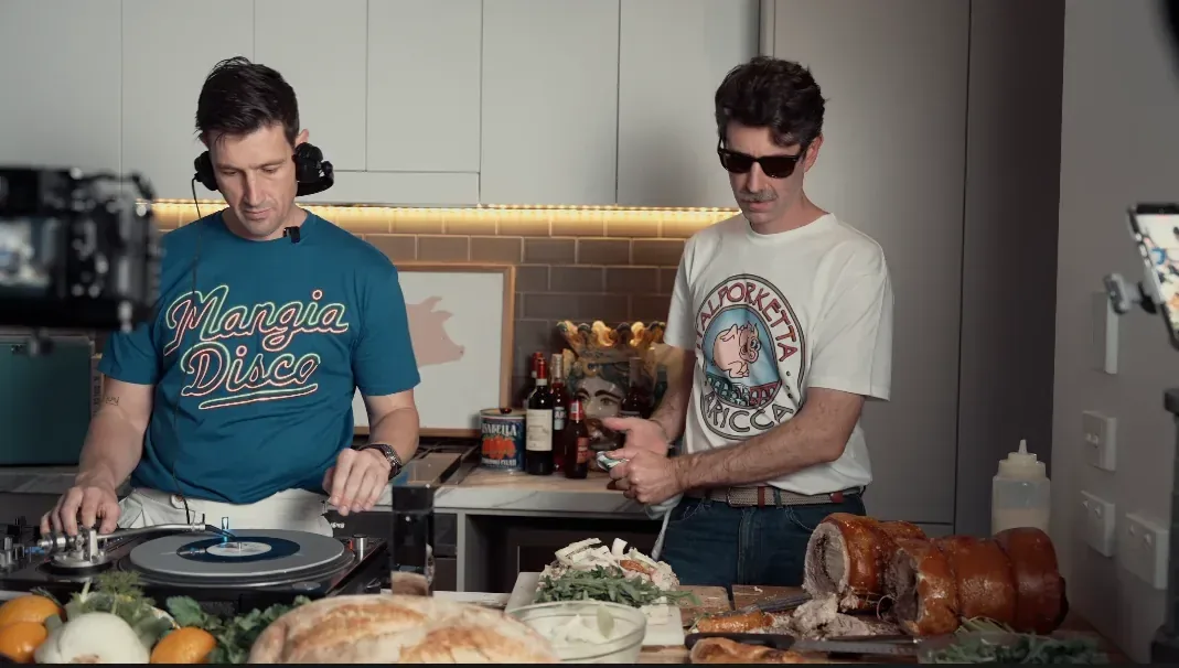 Matt and Andy mixing records and preparing porchetta in the Mangia Disco kitchen